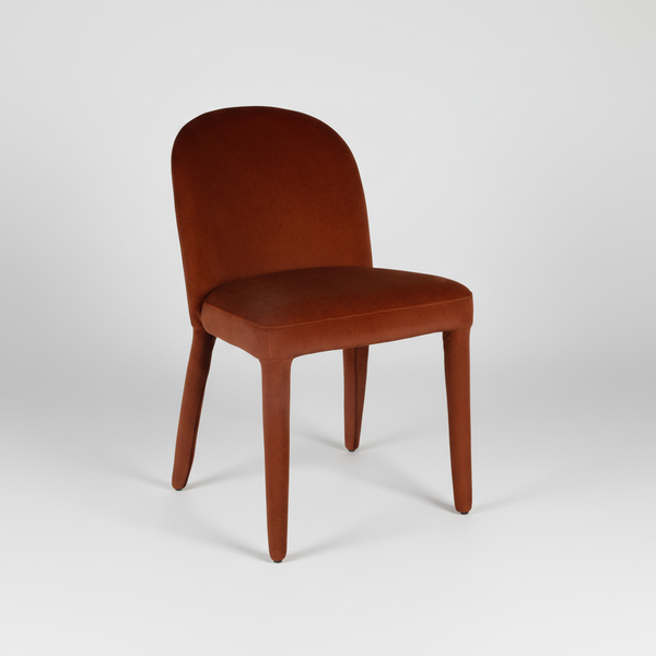 Rust upholstered dining chair with rounded backrest, padded seat, and four tapered legs