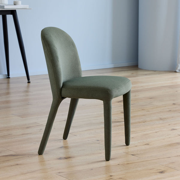 Olive upholstered dining chair with curved back and four tapered legs