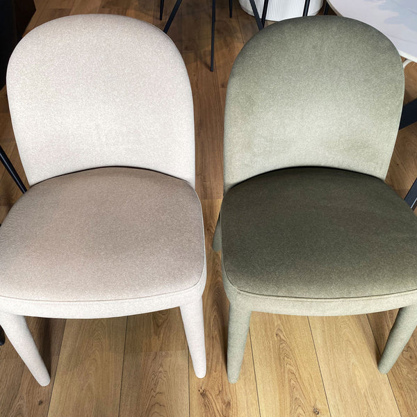 Pair of upholstered dining chairs with rounded backs and linen seats, light and olive.