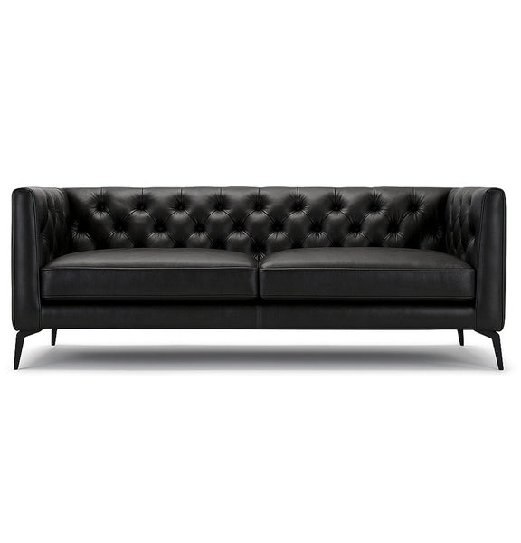 Black leather Chesterfield sofa with tufted back, two seat cushions, and tapered legs