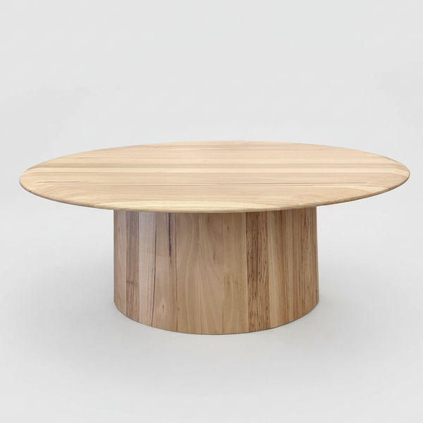 Round wood coffee table, light natural finish, wide flat top on cylindrical base