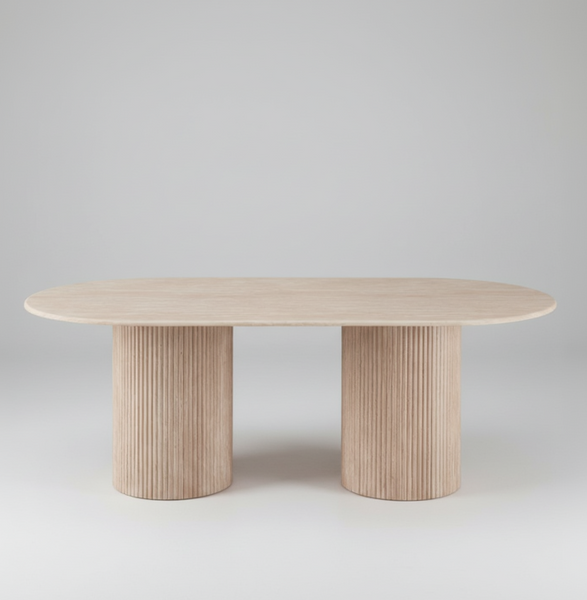 Oval dining table with light wood top and two fluted pedestal bases