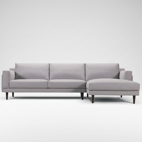 Light gray fabric chaise sectional sofa with three cushions and dark tapered legs.