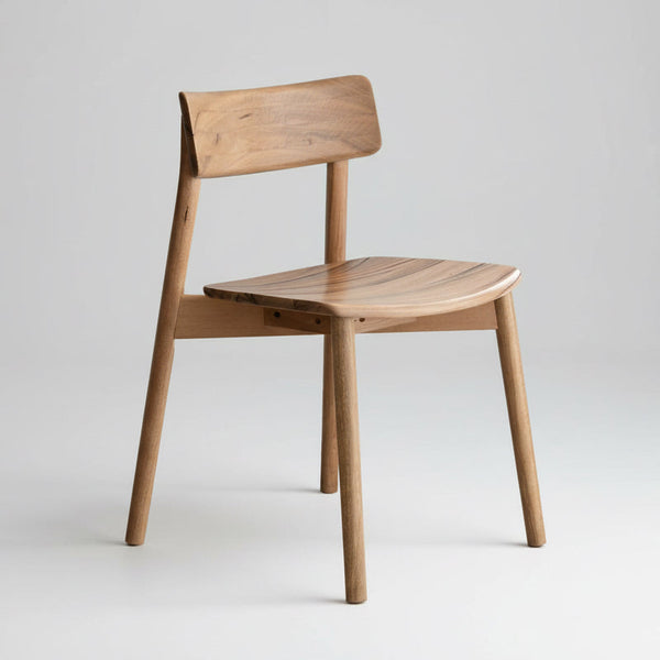 Wood dining chair with curved backrest and rounded seat, tapered legs