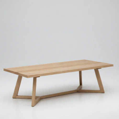 Light wood rectangular coffee table with angled legs and open shelf base.
