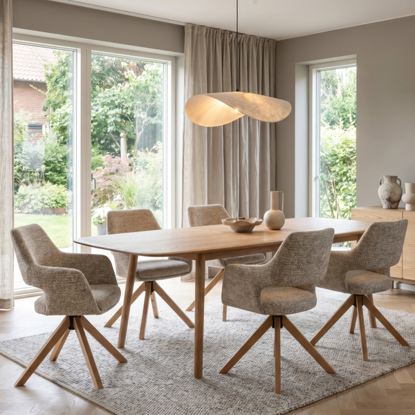 Dining table with light wood top and beige upholstered chairs