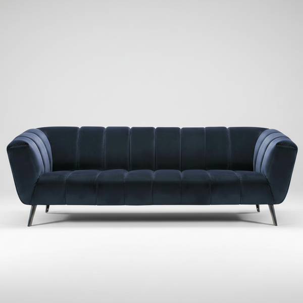 Tufted velvet sofa with rolled arms, dark blue upholstery, and tapered metal legs.