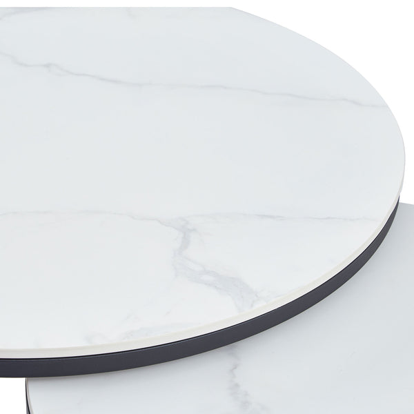 Close-up of white marble-look round tabletop edge with black metal rim