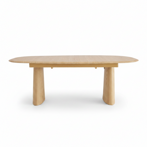 Oval extension dining table with light wood top and four tapered pedestal legs