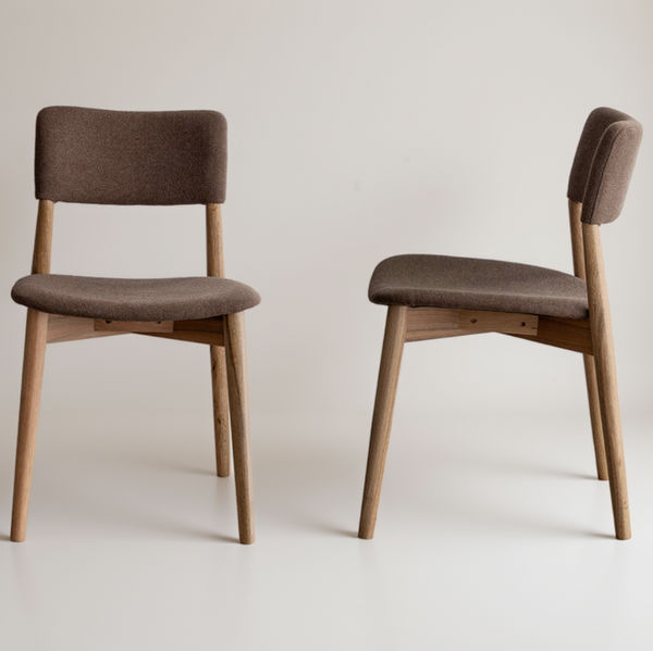 Two wooden dining chairs with brown upholstered seats and backs, shown from front and side angles on a plain white background.