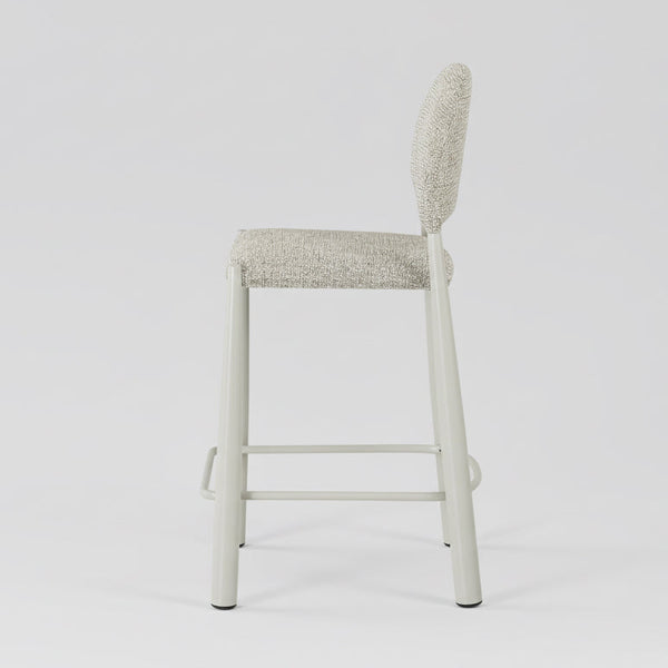 Sunday bar stool side view with light beige upholstered back and seat, white metal legs