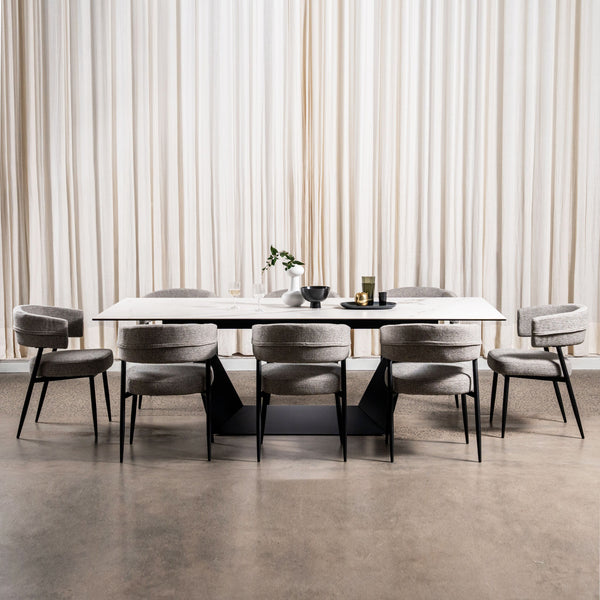Dining table with eight upholstered dining chairs, gray fabric and black metal legs