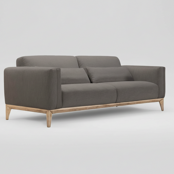 Gray upholstered sofa with wide arms, back cushions, seat cushions, and light wood legs