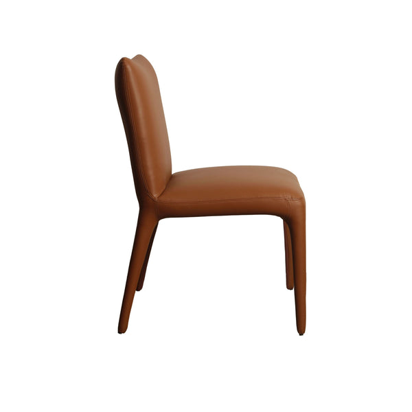Tan upholstered dining chair side view with curved back and tapered legs