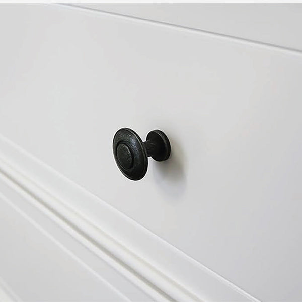 White dresser drawer front with round black knobs and panel detail