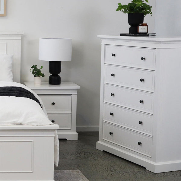 White bed frame with paneled headboard and two matching nightstands