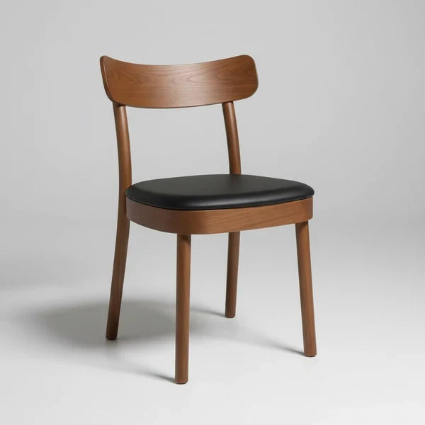 A mid-century modern wooden dining chair with a warm brown wood frame and a black upholstered seat cushion, shown on a light gray studio background.