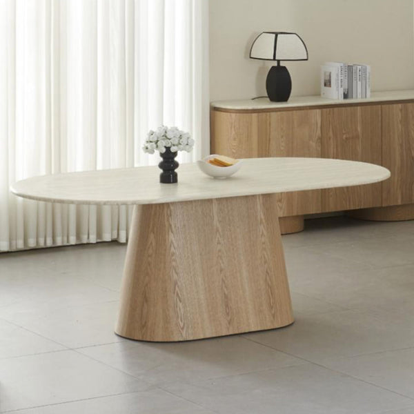 Light wood dining table with round top and single pedestal base
