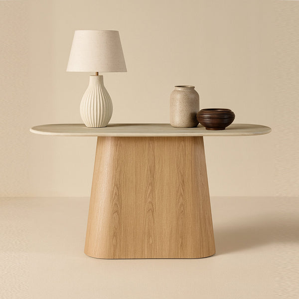 Light wood console table with round top and pedestal base.