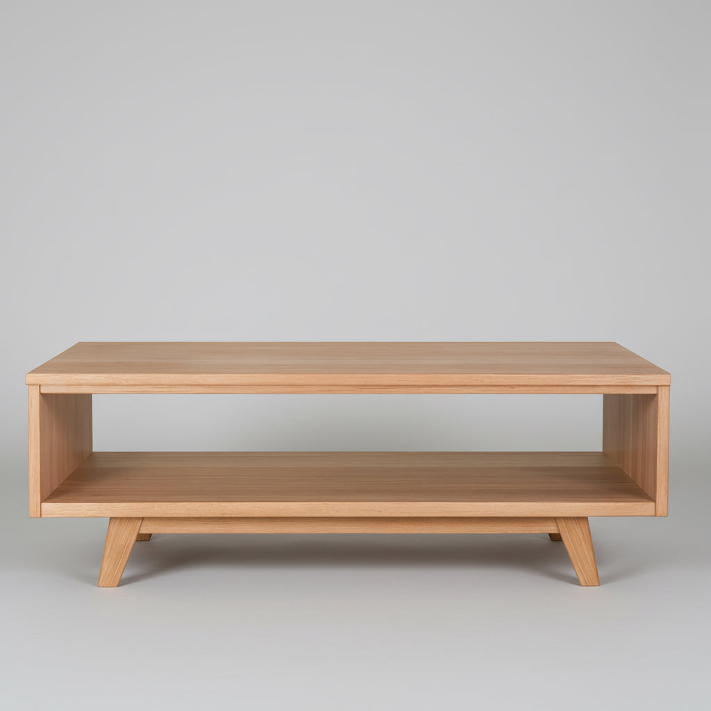 Light wood coffee table with open lower shelf and rectangular top.